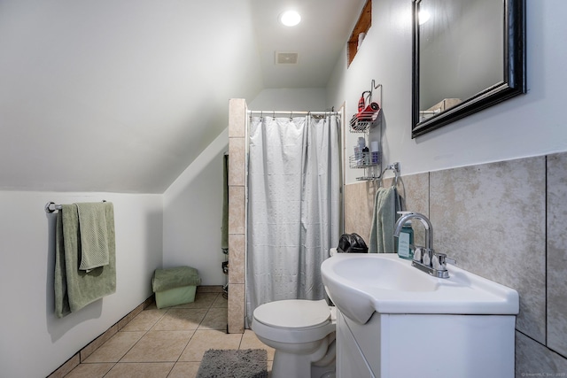 bathroom with vanity, vaulted ceiling, toilet, tile patterned floors, and visible vents