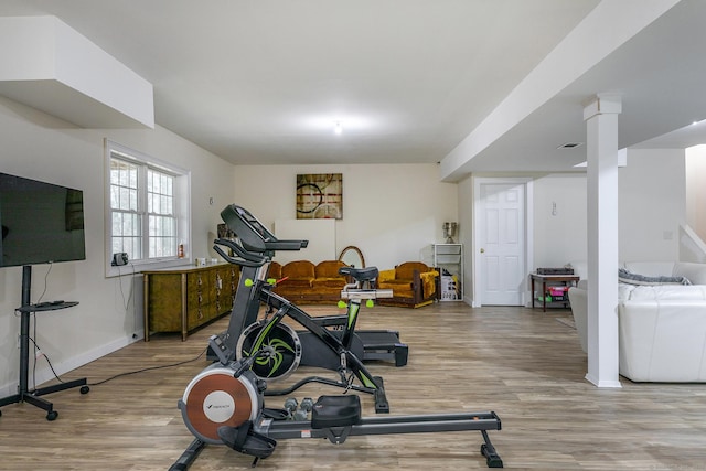 workout room featuring baseboards, visible vents, and light wood-style floors