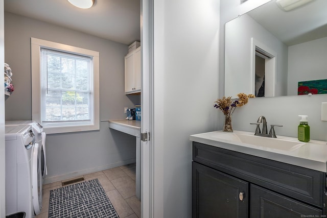 bathroom with vanity, baseboards, washing machine and clothes dryer, tile patterned floors, and visible vents