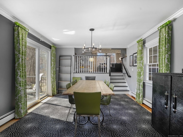 dining room with crown molding, a healthy amount of sunlight, a chandelier, and wood finished floors