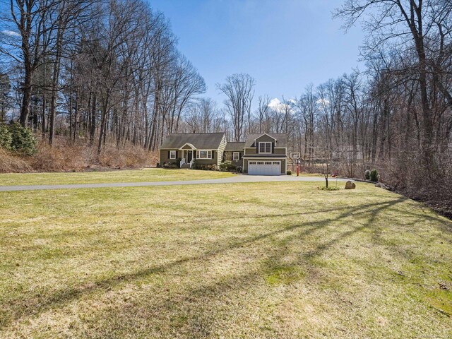 view of yard with driveway and an attached garage