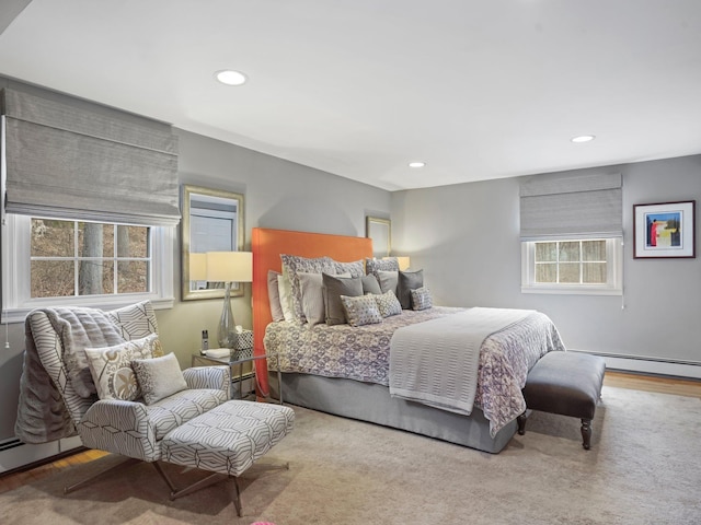bedroom with recessed lighting and baseboard heating