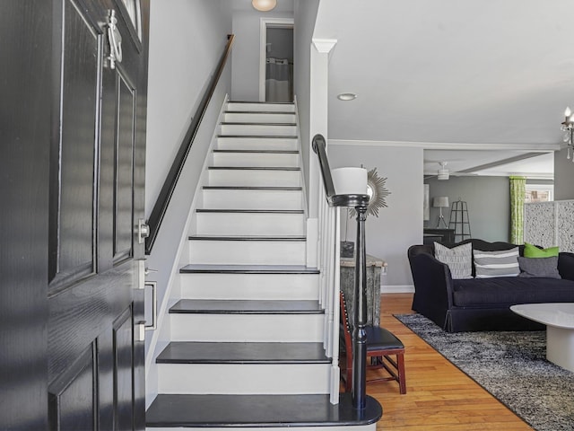 staircase with baseboards and wood finished floors