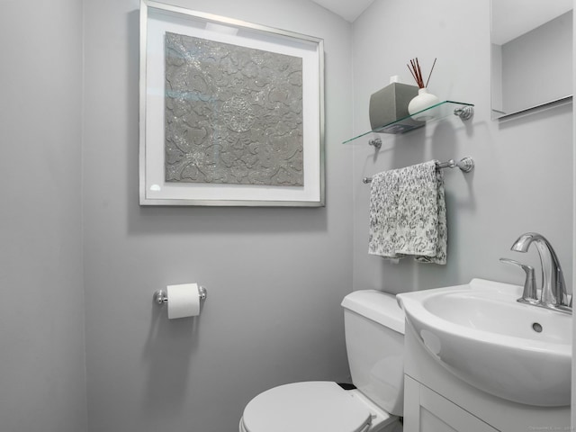 half bathroom featuring toilet and vanity