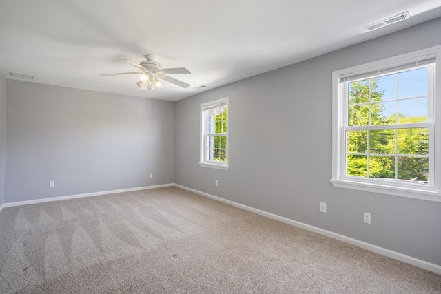 empty room with baseboards, light carpet, and ceiling fan