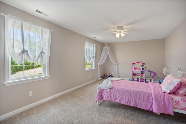 bedroom featuring multiple windows, carpet flooring, baseboards, and a ceiling fan