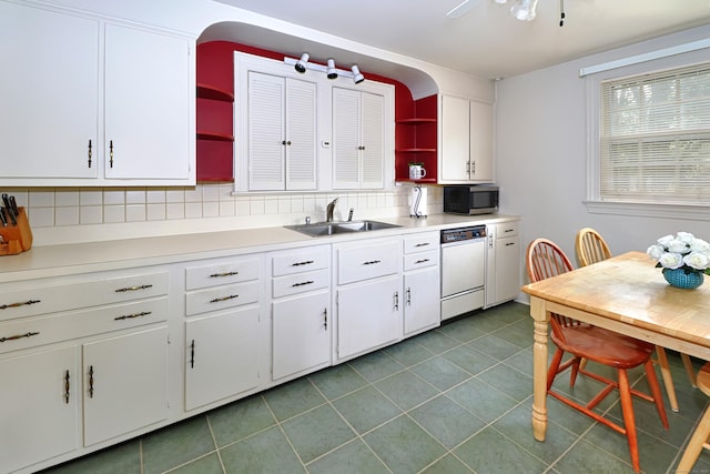 kitchen featuring dishwasher, stainless steel microwave, open shelves, and a sink