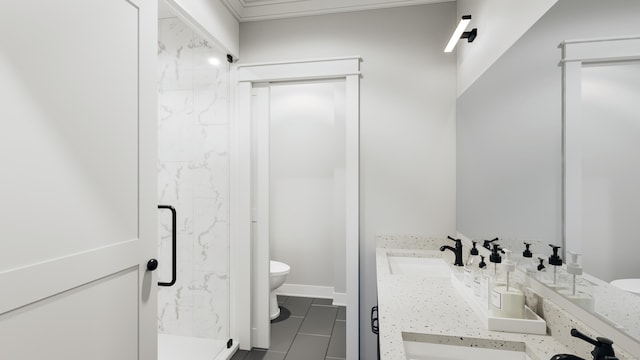 full bath with double vanity, toilet, a marble finish shower, and a sink