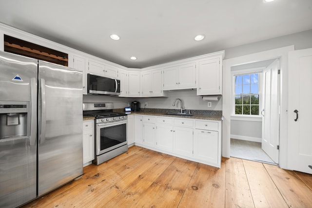 741 Mapleton Ave, Suffield, CT 06078 - kitchen featuring stainless steel appliances, white cabinets, light wood finished floors, recessed lighting, and dark stone counters