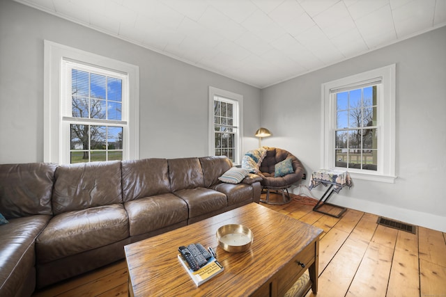 741 Mapleton Ave, Suffield, CT 06078 - living room with healthy amount of natural light, hardwood / wood-style floors, and ornamental molding