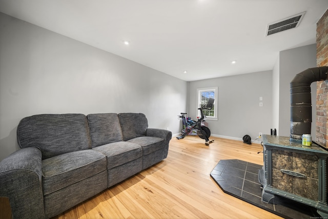 741 Mapleton Ave, Suffield, CT 06078 - living room featuring a wood stove, wood finished floors, and recessed lighting