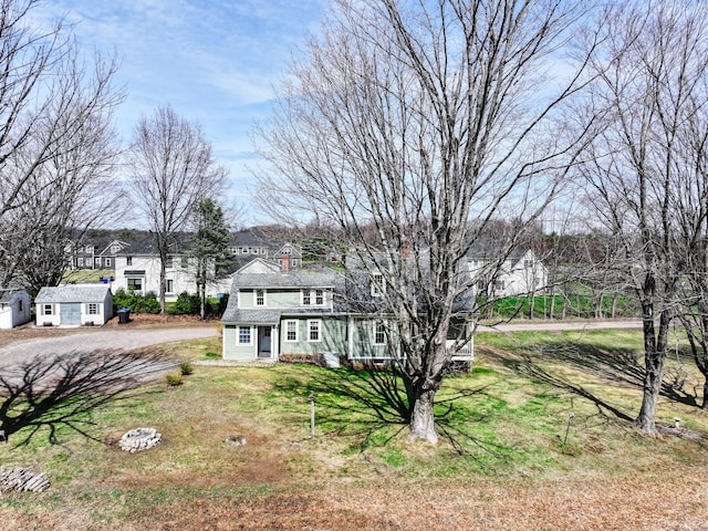 741 Mapleton Ave, Suffield, CT 06078 - view of front facade with a front lawn, driveway, an outbuilding, and a residential view
