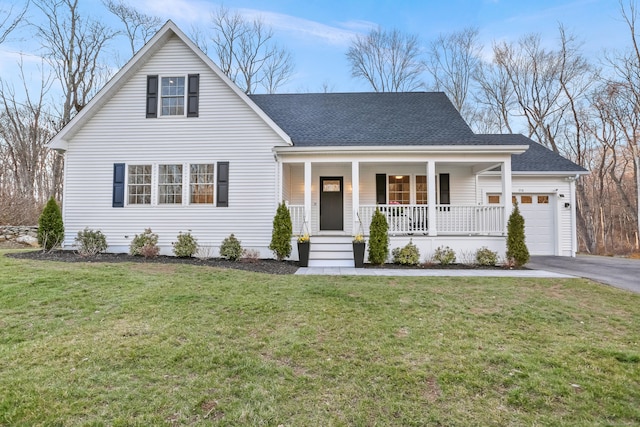 view of front facade with an attached garage, a front lawn, roof with shingles, driveway, and a porch