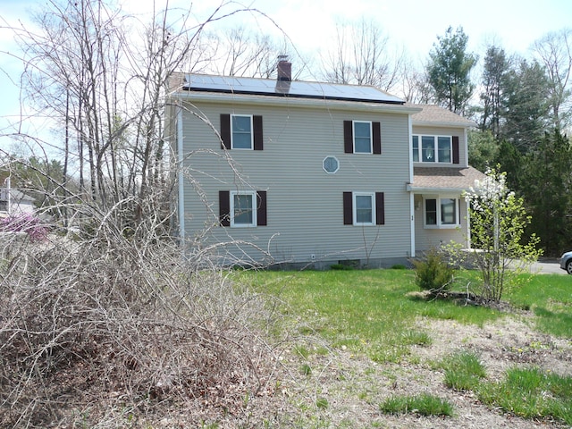 64 Chestnut Cir, Suffield, CT 06093 - back of house featuring a chimney and solar panels
