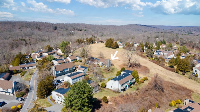 drone / aerial view with a residential view and a wooded view