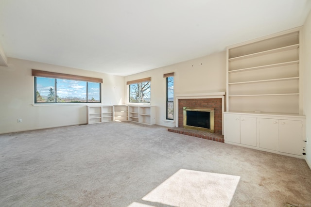 unfurnished living room with carpet and a fireplace