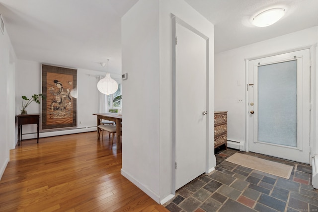 8 Lyle Ct Unit J, Farmington, CT 06032 - foyer entrance featuring a baseboard heating unit, hardwood / wood-style flooring, and baseboards