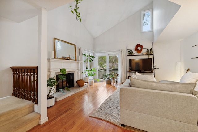 8 Lyle Ct Unit J, Farmington, CT 06032 - living room featuring hardwood / wood-style floors, a glass covered fireplace, high vaulted ceiling, and stairway