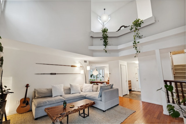 8 Lyle Ct Unit J, Farmington, CT 06032 - living room featuring a high ceiling, wood-type flooring, stairway, and baseboards