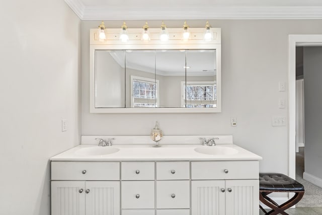 full bathroom with double vanity, baseboards, a sink, and ornamental molding
