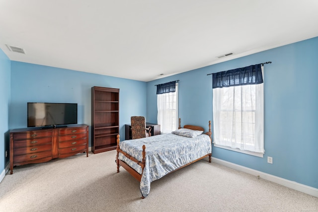 carpeted bedroom featuring visible vents and baseboards
