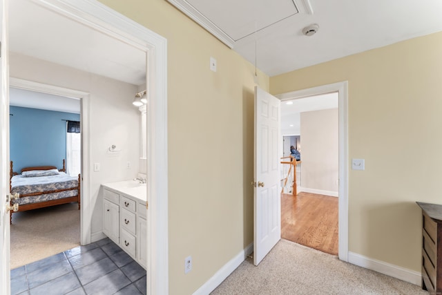 bathroom with ensuite bathroom, baseboards, and vanity