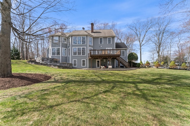 rear view of property with a yard, stairway, a wooden deck, and a chimney