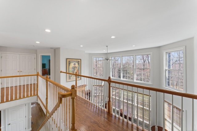 hallway featuring recessed lighting, an upstairs landing, and wood finished floors