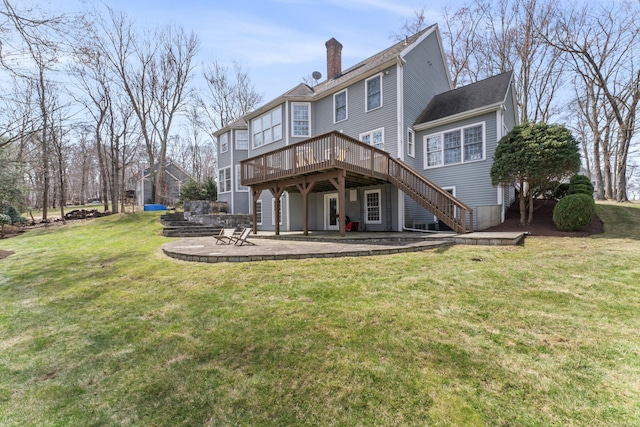 rear view of house with a lawn, a chimney, stairway, a patio, and a wooden deck