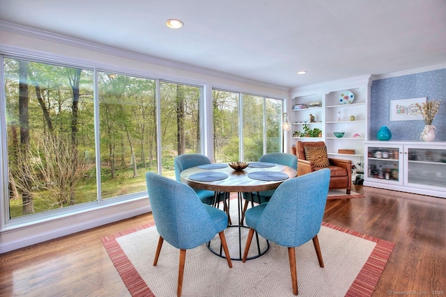 interior space featuring crown molding and wood finished floors