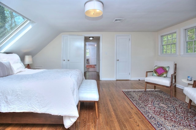 bedroom featuring visible vents, wood finished floors, and baseboards