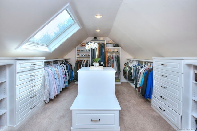 walk in closet featuring lofted ceiling with skylight and light colored carpet