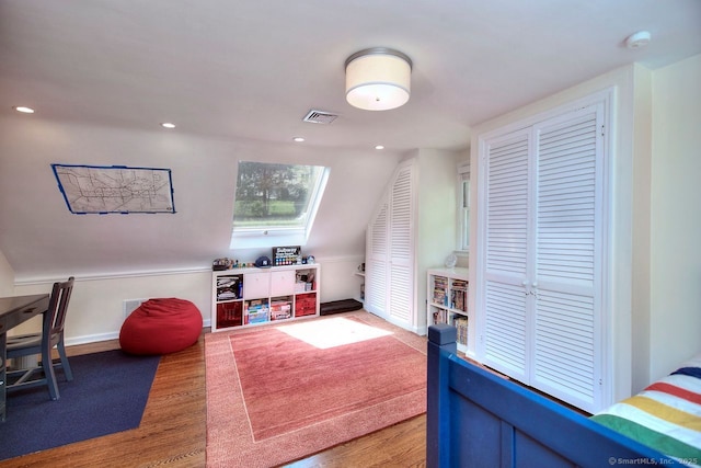 game room featuring lofted ceiling, baseboards, visible vents, and wood finished floors