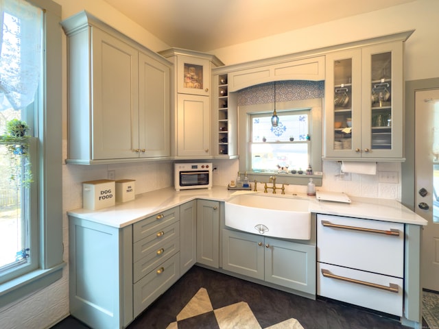 1063 Main St, South Windsor, CT 06074 - kitchen with light countertops, glass insert cabinets, decorative backsplash, and gray cabinetry