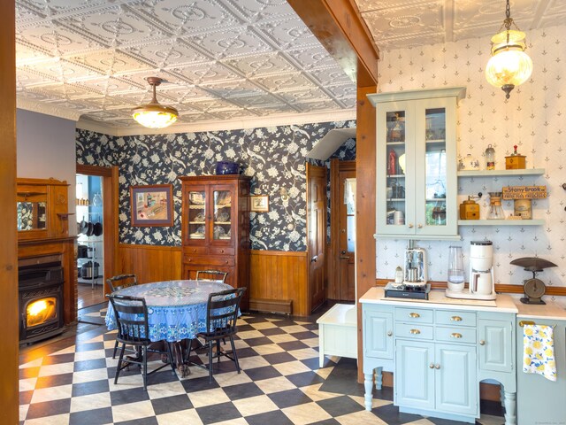 1063 Main St, South Windsor, CT 06074 - dining area featuring a wainscoted wall, an ornate ceiling, light floors, ornamental molding, and a wood stove