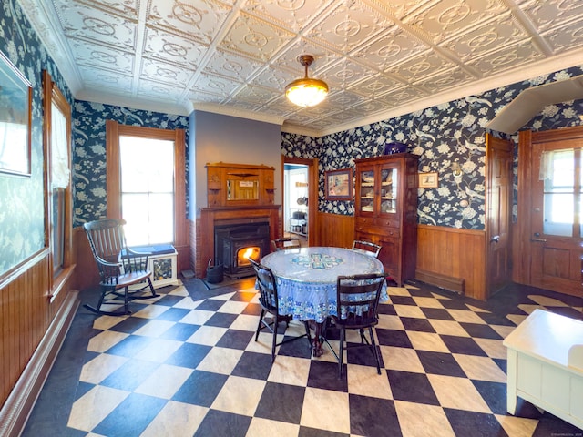 1063 Main St, South Windsor, CT 06074 - dining space with a wainscoted wall, tile patterned floors, an ornate ceiling, crown molding, and wooden walls