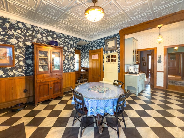 1063 Main St, South Windsor, CT 06074 - dining area featuring tile patterned floors, wainscoting, and wallpapered walls