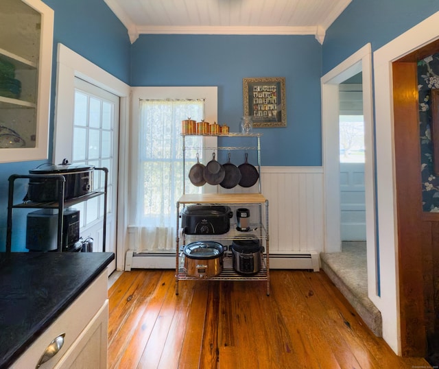 1063 Main St, South Windsor, CT 06074 - dining room featuring crown molding, hardwood / wood-style floors, and wainscoting