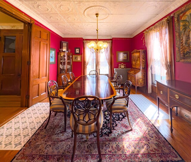 1063 Main St, South Windsor, CT 06074 - dining room with wood finished floors, healthy amount of natural light, a chandelier, ornamental molding, and an ornate ceiling