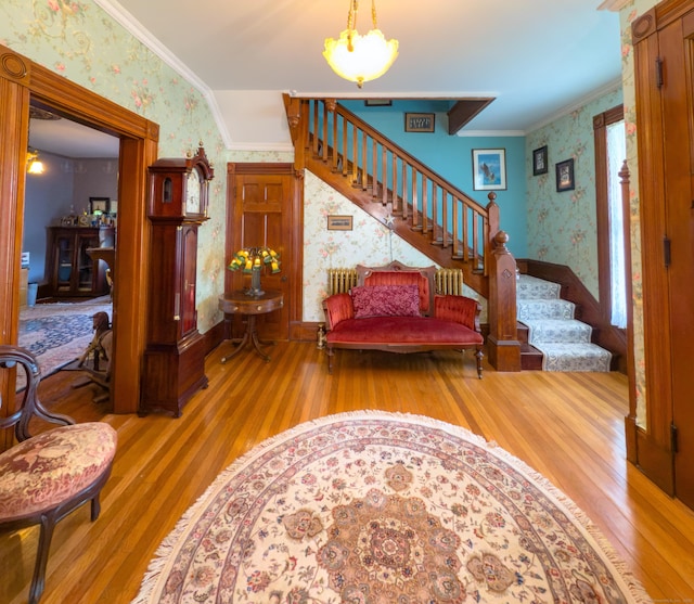 1063 Main St, South Windsor, CT 06074 - foyer entrance featuring wallpapered walls, wood finished floors, stairway, ornamental molding, and a chandelier