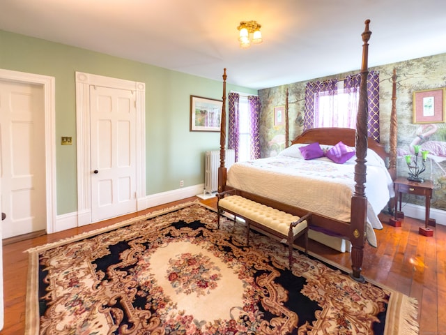 1063 Main St, South Windsor, CT 06074 - bedroom featuring radiator heating unit and hardwood / wood-style flooring