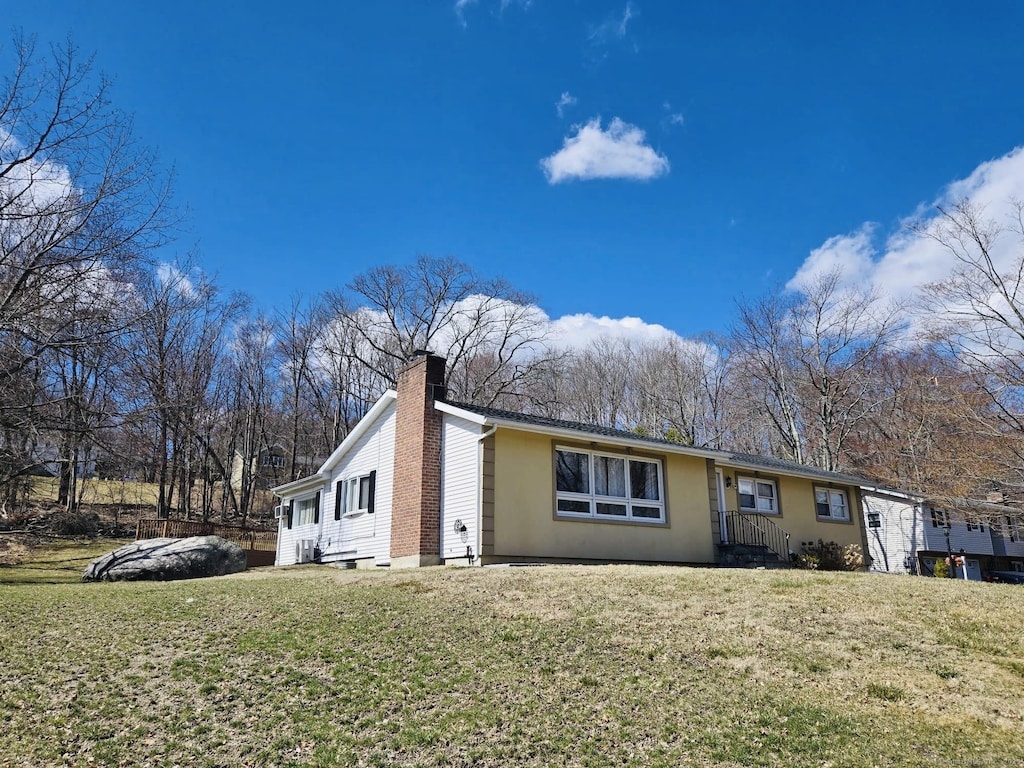 3 Indian Hill Rd, New Fairfield, CT 06812 - view of front facade with a chimney and a front yard