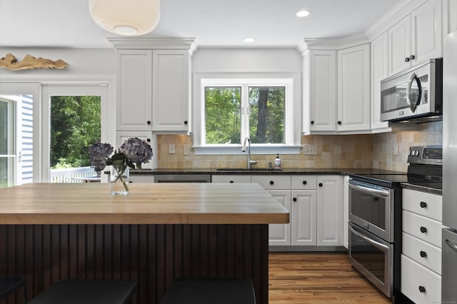 169 High Meadow Ln, Groton, CT 06355 - kitchen featuring stainless steel appliances, a sink, butcher block countertops, white cabinetry, and recessed lighting