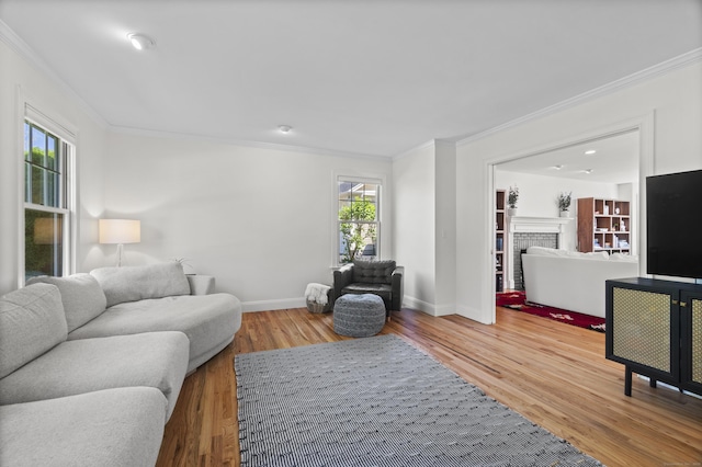169 High Meadow Ln, Groton, CT 06355 - living room featuring ornamental molding, baseboards, wood finished floors, and a brick fireplace