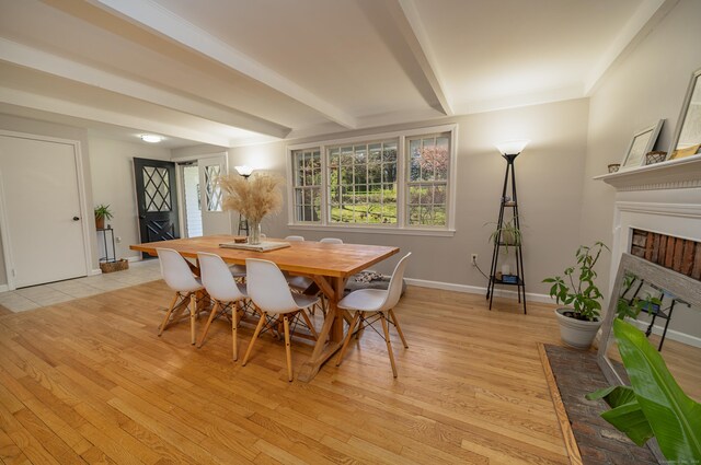 125 Northford Rd, Branford, CT 06405 - dining area featuring baseboards, beamed ceiling, a brick fireplace, and light wood-type flooring