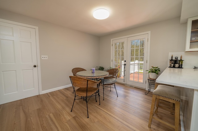 125 Northford Rd, Branford, CT 06405 - dining area featuring baseboards, french doors, and light wood finished floors