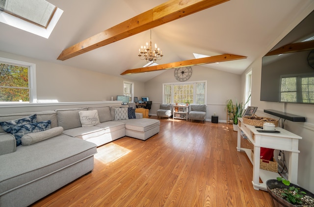 125 Northford Rd, Branford, CT 06405 - living room with an inviting chandelier, light wood-style floors, and vaulted ceiling with skylight
