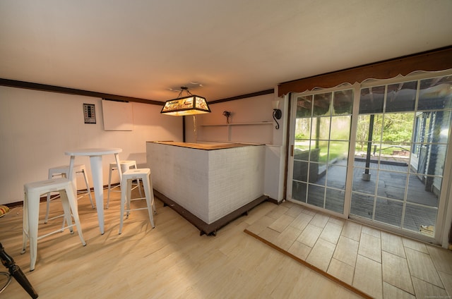 125 Northford Rd, Branford, CT 06405 - unfurnished dining area featuring bar area, ornamental molding, and light wood-type flooring