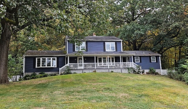 view of front of house with a porch, a shingled roof, and a front lawn