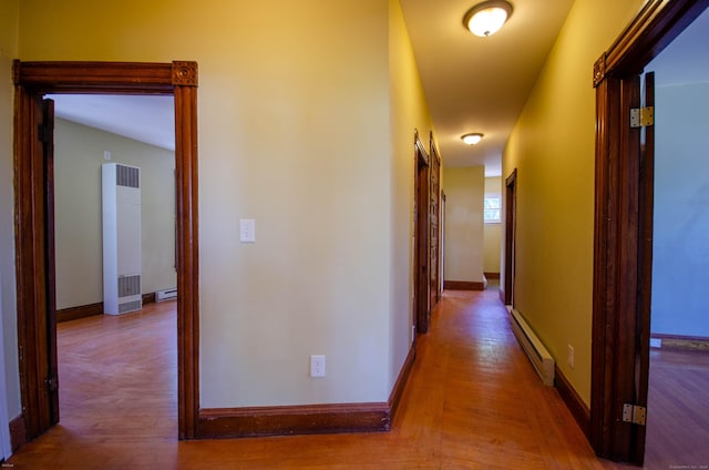 93 Broad St, Norwich, CT 06360 - hallway with a heating unit, baseboard heating, wood finished floors, and baseboards